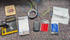 an array of small gadgets laid out on a tablecloth